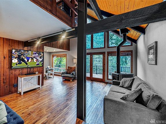 Step in the front door to this cozy great room with radiant heated floors and a view across the deck.