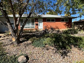Street view of house front with xeriscaped yard