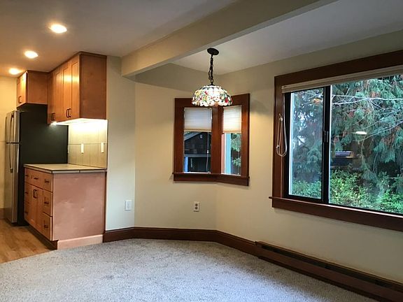 Roomy dining alcove with Tiffany lamp shade.