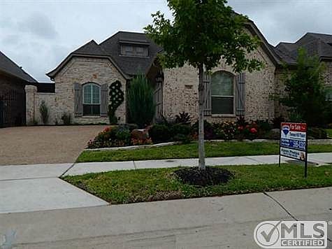 Beautiful landscaping decorates the yard.