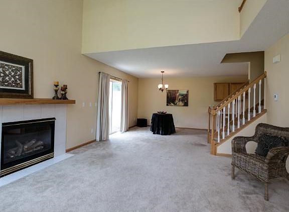 Living Room with valuted ceilings, ceiling fan and gas fireplace.
