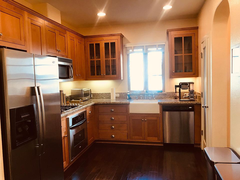 Kitchen with stainless steel appliances, granite countertop, and recessed lighting for dimming options so you can set the mood for at home dinners