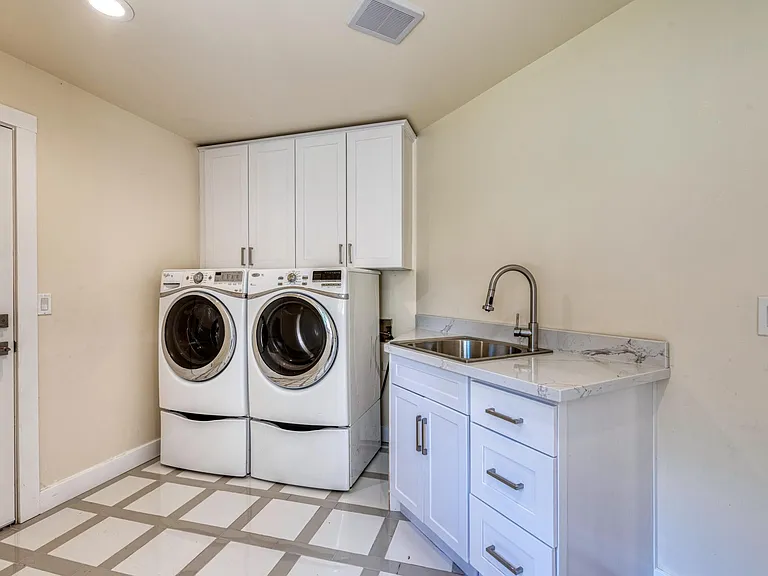 Laundry room area with door access to the garage. Washer and Dryer stay!