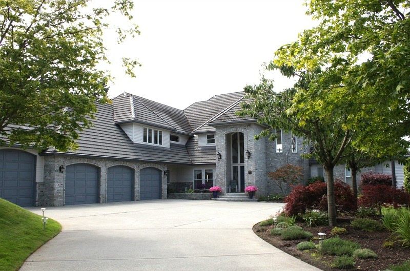Stately home past gated entry. Brick and Wood exterior with tile roof, four car garage. Beautifully landscaped grounds. Unobstructed Bellingham Bay and Island Views.