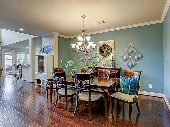 Desirable open floor plan, large dining room, with crown molding, wood floors, and designer paint.