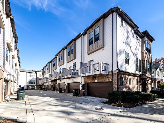 Driveway showcasing two car garage and back porch that sits off the kitchen.