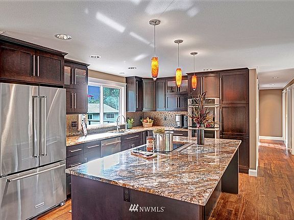 Stunning Remodeled Kitchen with Open Floor plan and newly refinished Brazilian hardwoods. You will fall in love with the extensive cabinetry and newer appliances. 