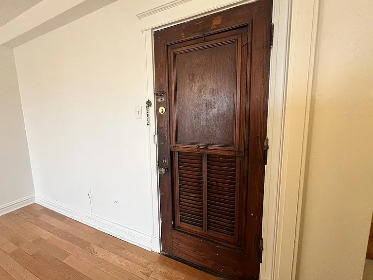 Original historic door has built-in screen to provide cross breezes.