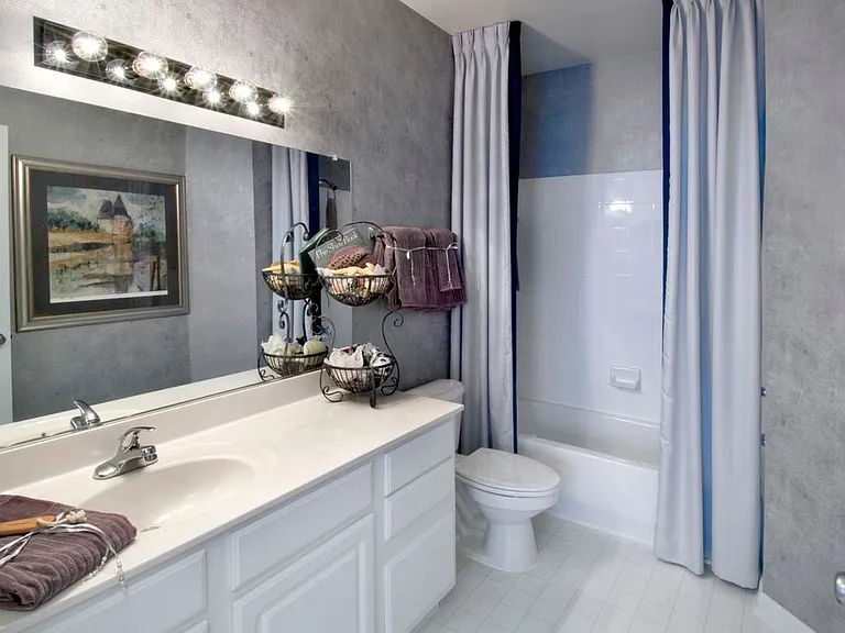 Classic Package bath with white cabinetry, white countertops, and tile flooring
