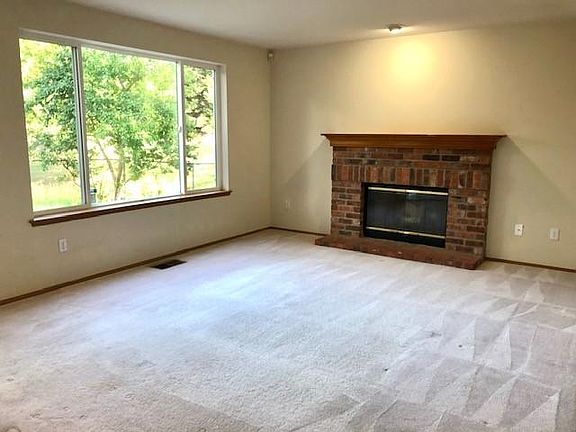 Large and bright family room with fire place.
