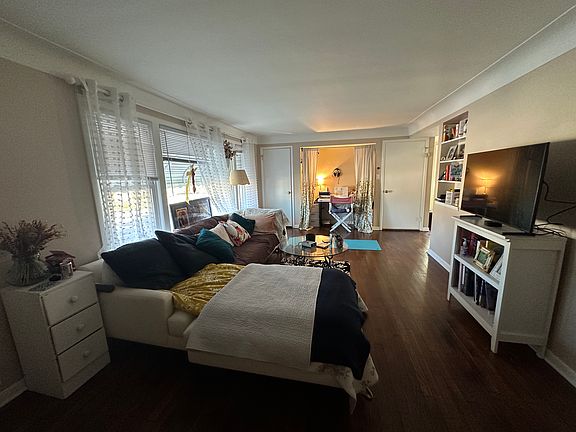 Living room from other end with nook and built in bookshelves