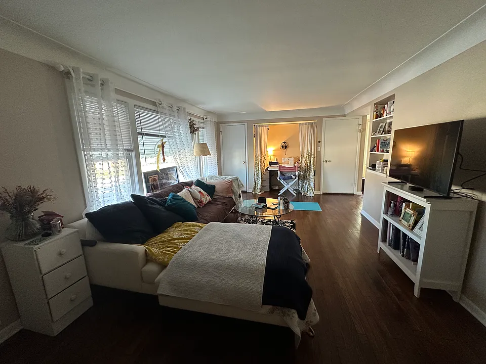 Living room from other end with nook and built in bookshelves