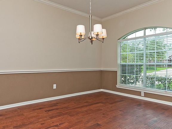 Formal dining room with engineered hardwood flooring to the right of the entry hall