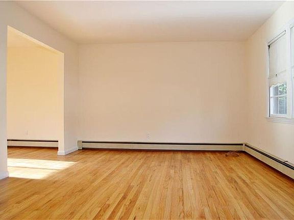 Living Room, empty. Entire apartment will be repainted white.