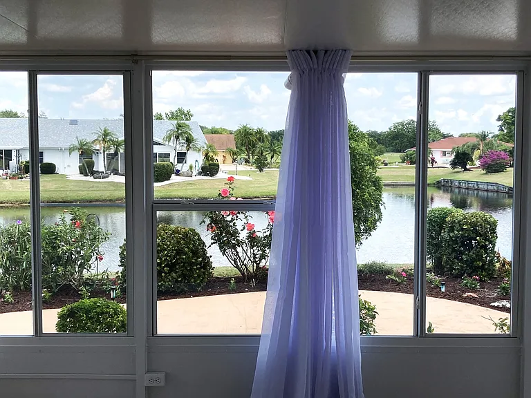 Water and garden view from enclosed lanai