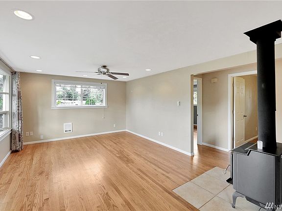 Large living room with wood burning stove. 