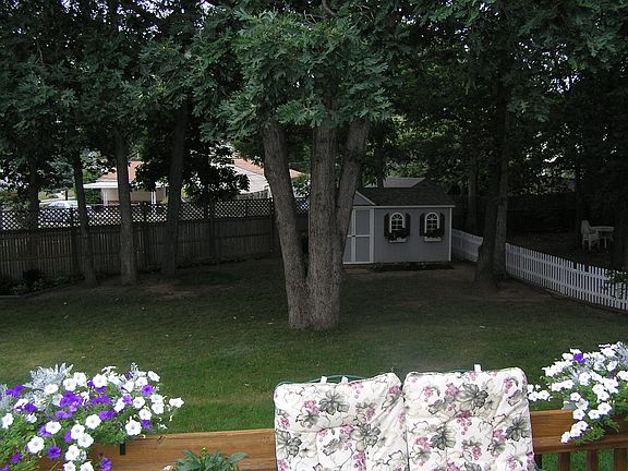 View of fully-fenced yard from lovely deck.