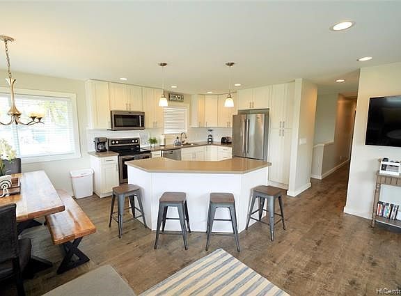 Share meals on the beautiful wood dining table or the kitchen island.