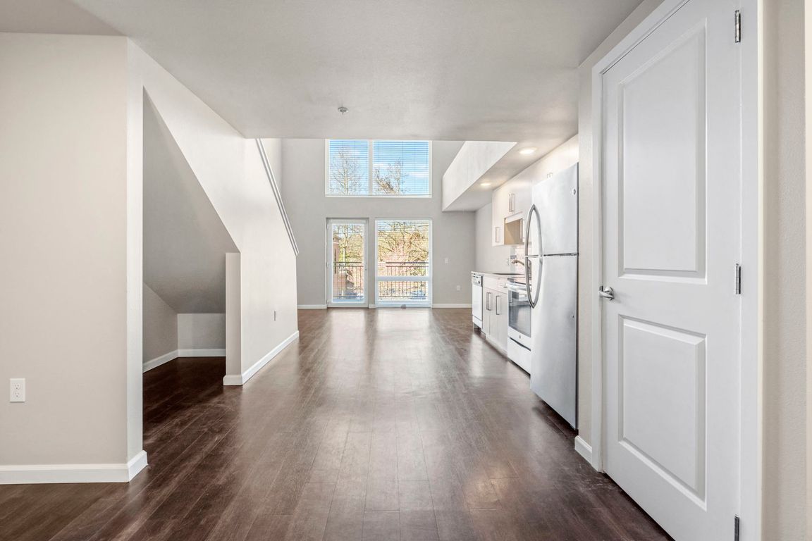Enjoy the spacious living room with hardwood floors and natural light, perfect for relaxation and entertaining.