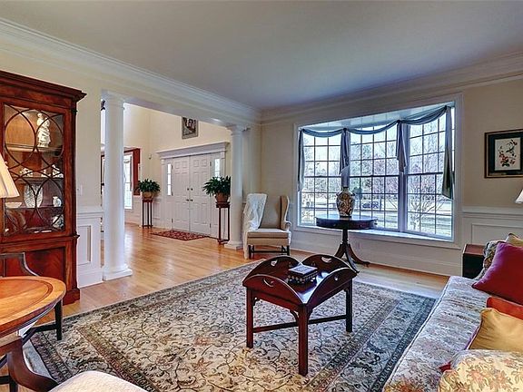 Living Room - Columns. Bay window. Double-wide crown molding. Chair Rail. Picture framing.