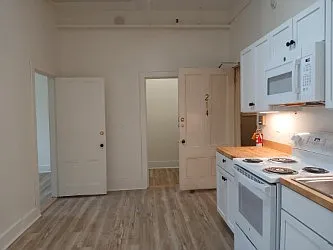 Renovated in 2025 Kitchen with new laminate flooring, new cabinets, appliances and large pantry