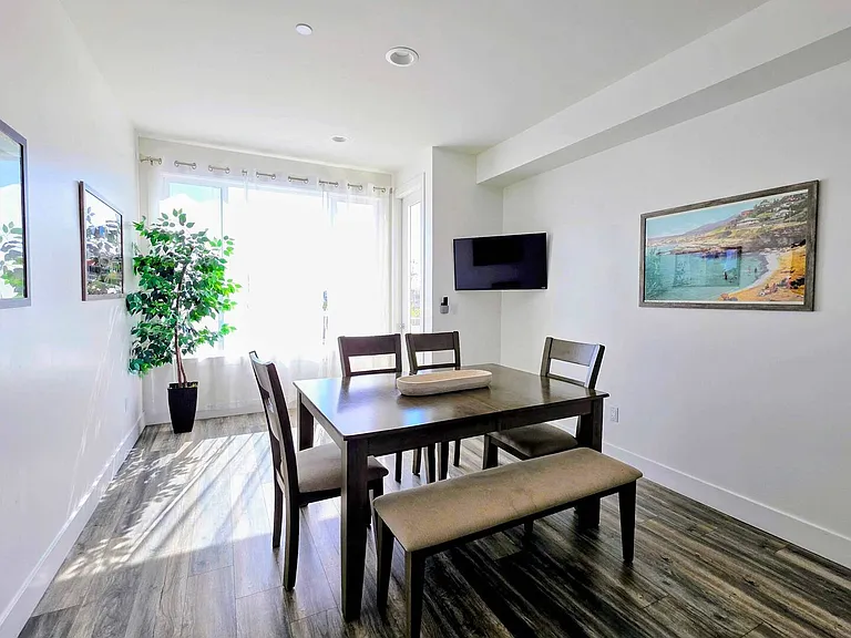 Dining area with seating, TV, and lots of light
