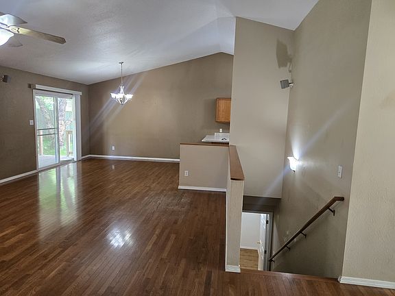 Dining area and stair access to lower level, living room view.