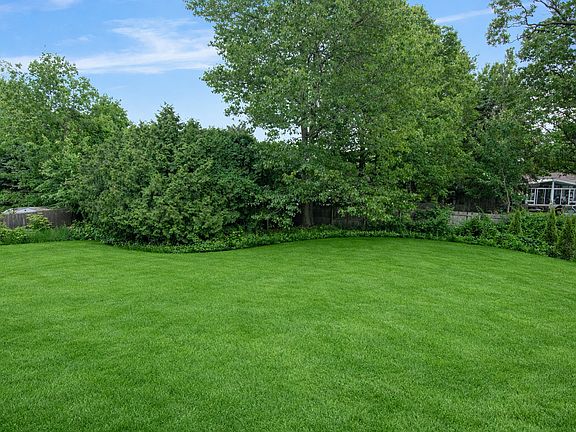 Main backyard with stone patio under oak tree