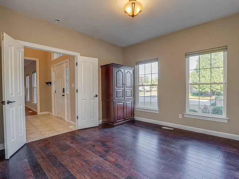 downstairs Bedroom with hickory wood floors can be a private Home Office, has attached Full Bathroom/shower.