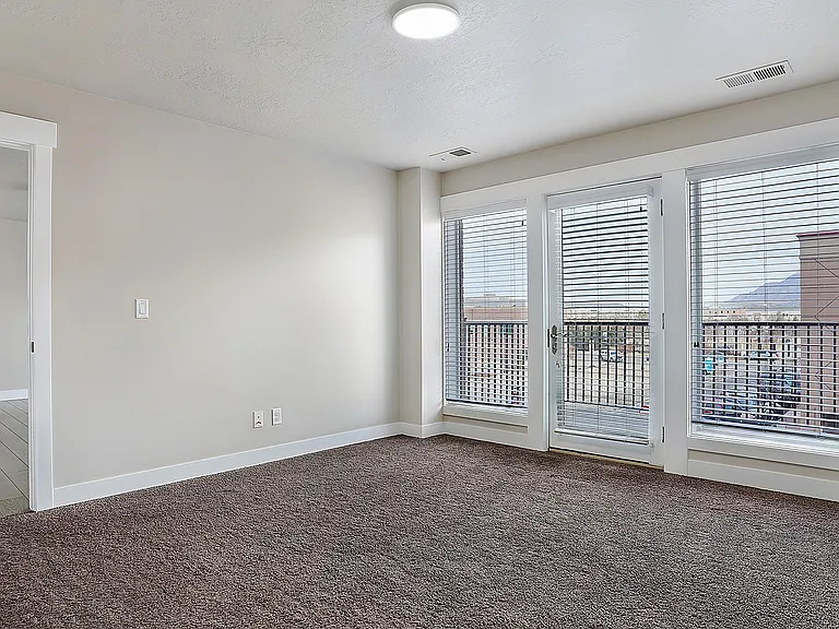 Spacious bedrooms offer natural light and private balcony access at Junction View.