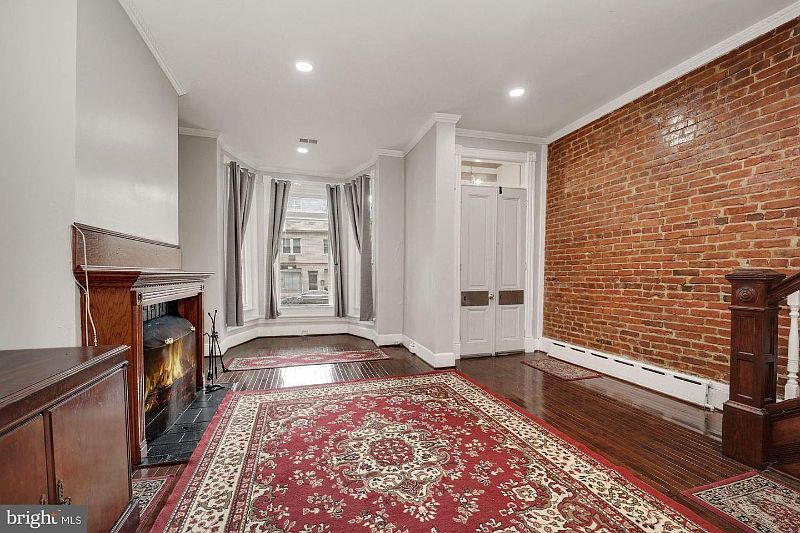 Welcome. Large Ballroom DR with walk-in bay window, exposed brick with FP