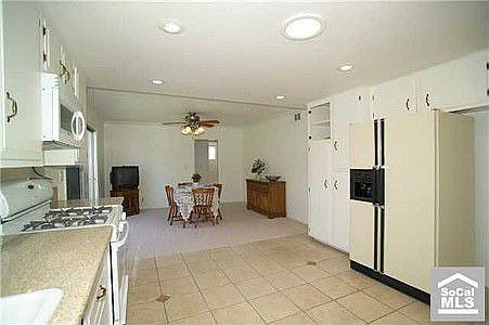 Looking west from laundry rm thru kit to fam rm/dining