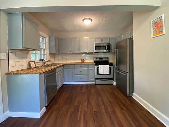 Kitchen - New cabinets. All the appliances included. Kitchen leads to screened in porch to enjoy meals outside. There is also space to set a small dining room table which can't be seen in this photo.
