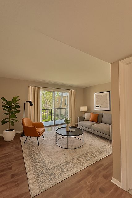 Living room leads out to large screened porch. Staged photo