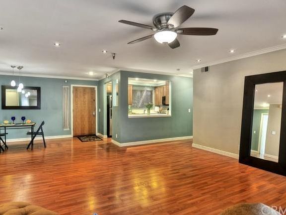 Living room facing the front door/dining area/kitchen