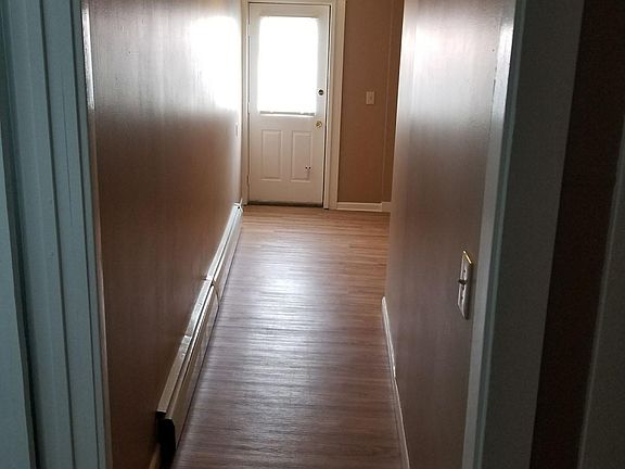 Hallway to private rear entrance and laundry