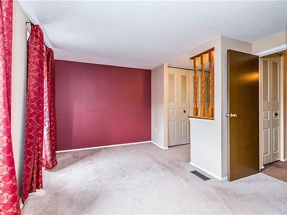 Master bedroom is spacious, includes a dressing area and access to the full bathroom on upper level.
