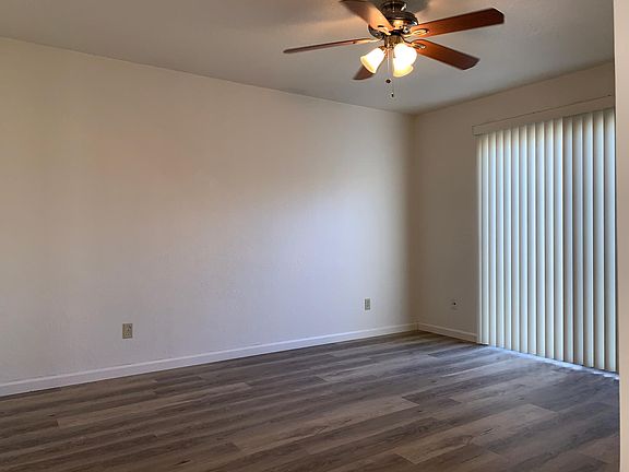 Master Bedroom With Ceiling Fan And Sliding Glass Door To Private Patio