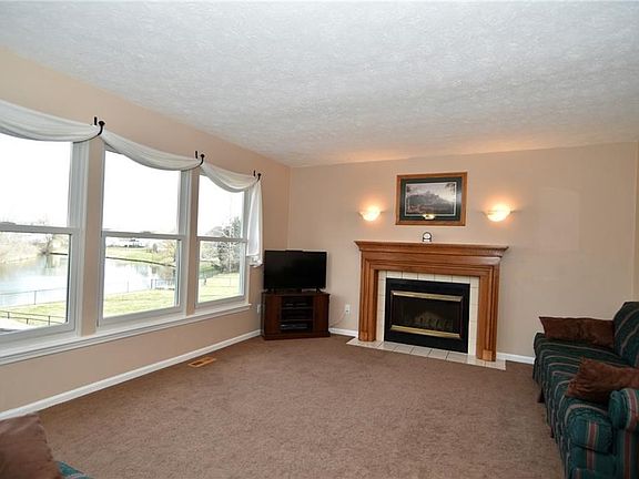 Family Room with wood-burning fireplace for those cold winter nights!  Check out the view through the windows!