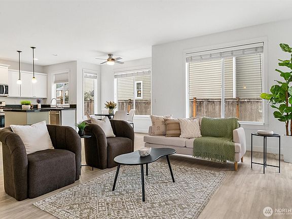 Spacious great room with large windows, neutral finishes, and flexible layout for comfortable everyday living.>
