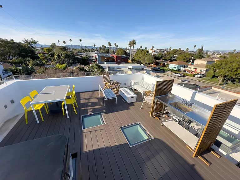 The 400 SF roof deck has a fire-pit, hot-tub, dining table, and seating area around a fire pit. The views and sense of owning the sky are unrivalled.
