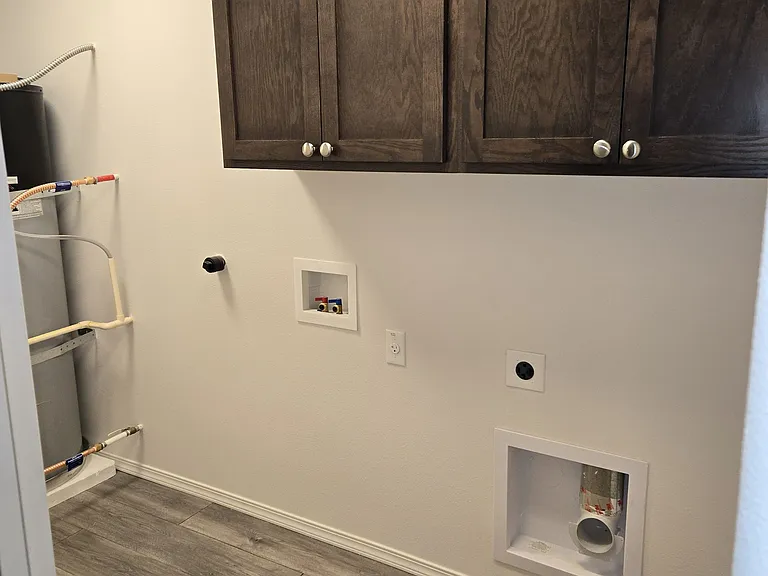 Laundry hook up with cabinets