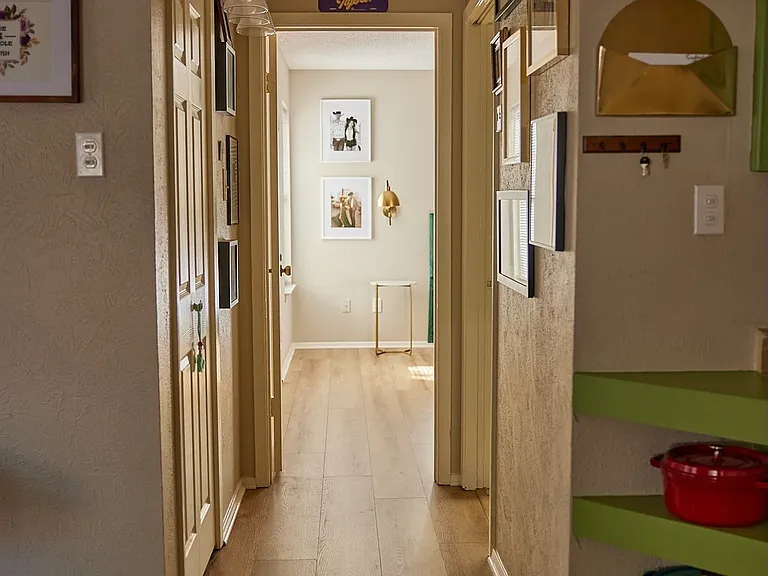 Hallway with light wood-style flooring and baseboards