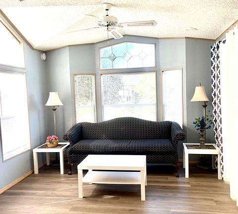 Living room with lots of natural light and vaulted celings.