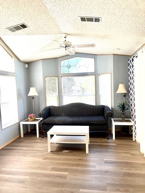 Living room with lots of natural light and vaulted celings.