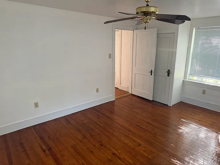 Second floor third bedroom with ceiling fan (back of house)