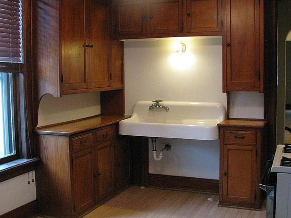 Kitchen with beautiful original cabinets and maple hardwood floors.