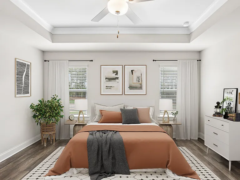 Primary bedroom with king size bed and large window.