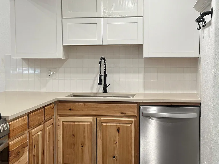 Brand new dishwasher, new upper and lower cabinets, and new sink.