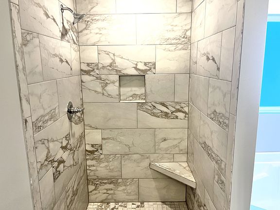 Owner s suite features tile shower, separate garden tub, and double vanities